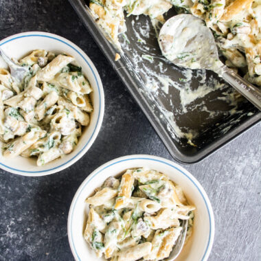 Penne pasta in homemade bechamel sauce with sautéed mushrooms and spinach