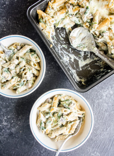 Penne pasta in homemade bechamel sauce with sautéed mushrooms and spinach