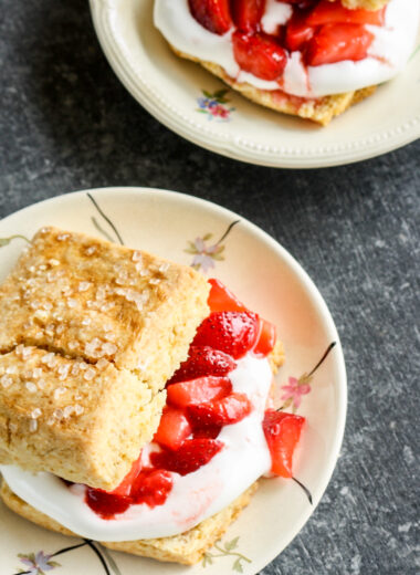 Tender, buttery sour cream biscuits sandwiched with fresh strawberries and sweetened whipped cream