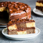 Buttery chocolate and vanilla cake assembled in a checkered pattern with a thick, fudgy chocolate frosting