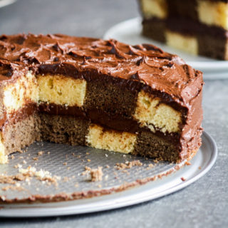 Buttery chocolate and vanilla cake assembled in a checkered pattern with a thick, fudgy chocolate frosting