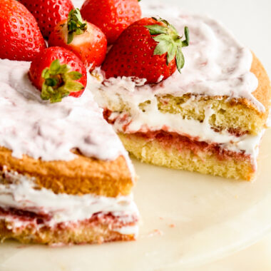 Light and fluffy Genoise sponge with homemade strawberry compote, whipped cream and fresh berries