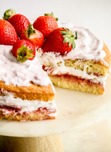 Light and fluffy Genoise sponge with homemade strawberry compote, whipped cream and fresh berries