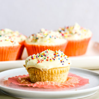 Soft and fluffy eggless vanilla cupcakes with tangy cream cheese frosting