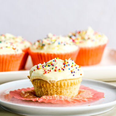 Soft and fluffy eggless vanilla cupcakes with tangy cream cheese frosting