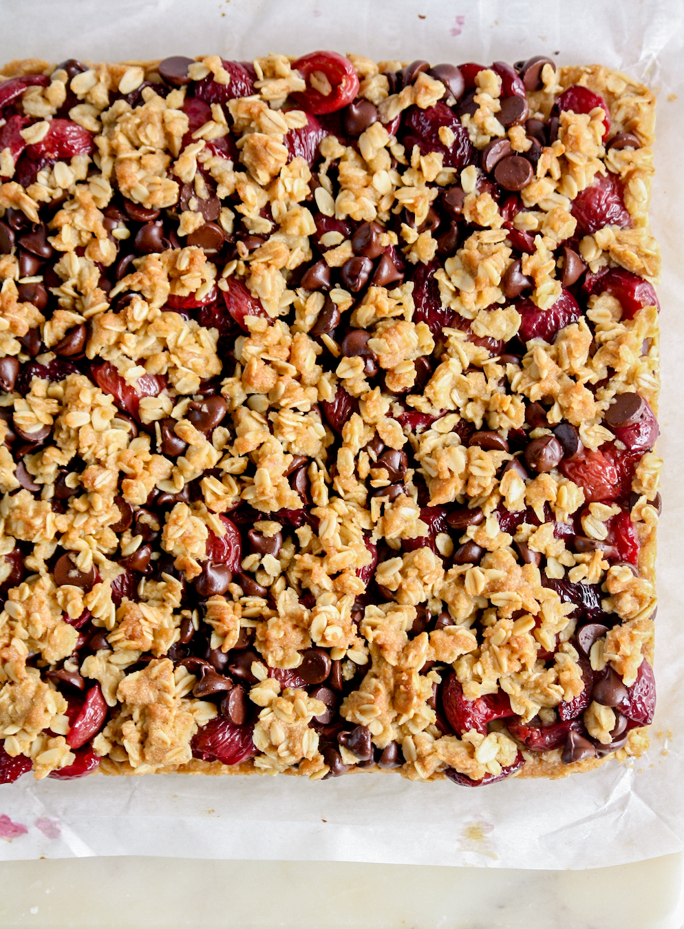 Chewy, crunchy oat crumble bars with roasted cherries and chocolate chips
