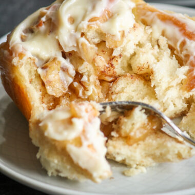 Soft, fluffy cinnamon rolls filled with caramelised apples!