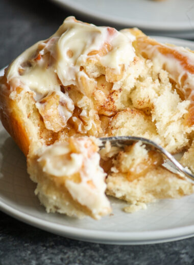 Soft, fluffy cinnamon rolls filled with caramelised apples!