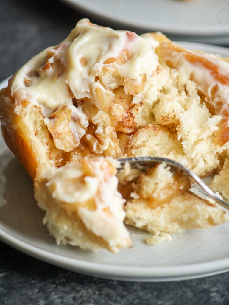 Soft, fluffy cinnamon rolls filled with caramelised apples!
