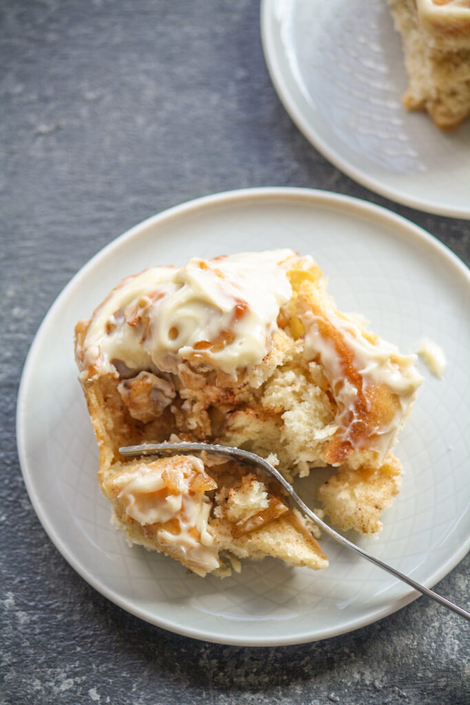 Soft, fluffy cinnamon rolls filled with caramelised apples!