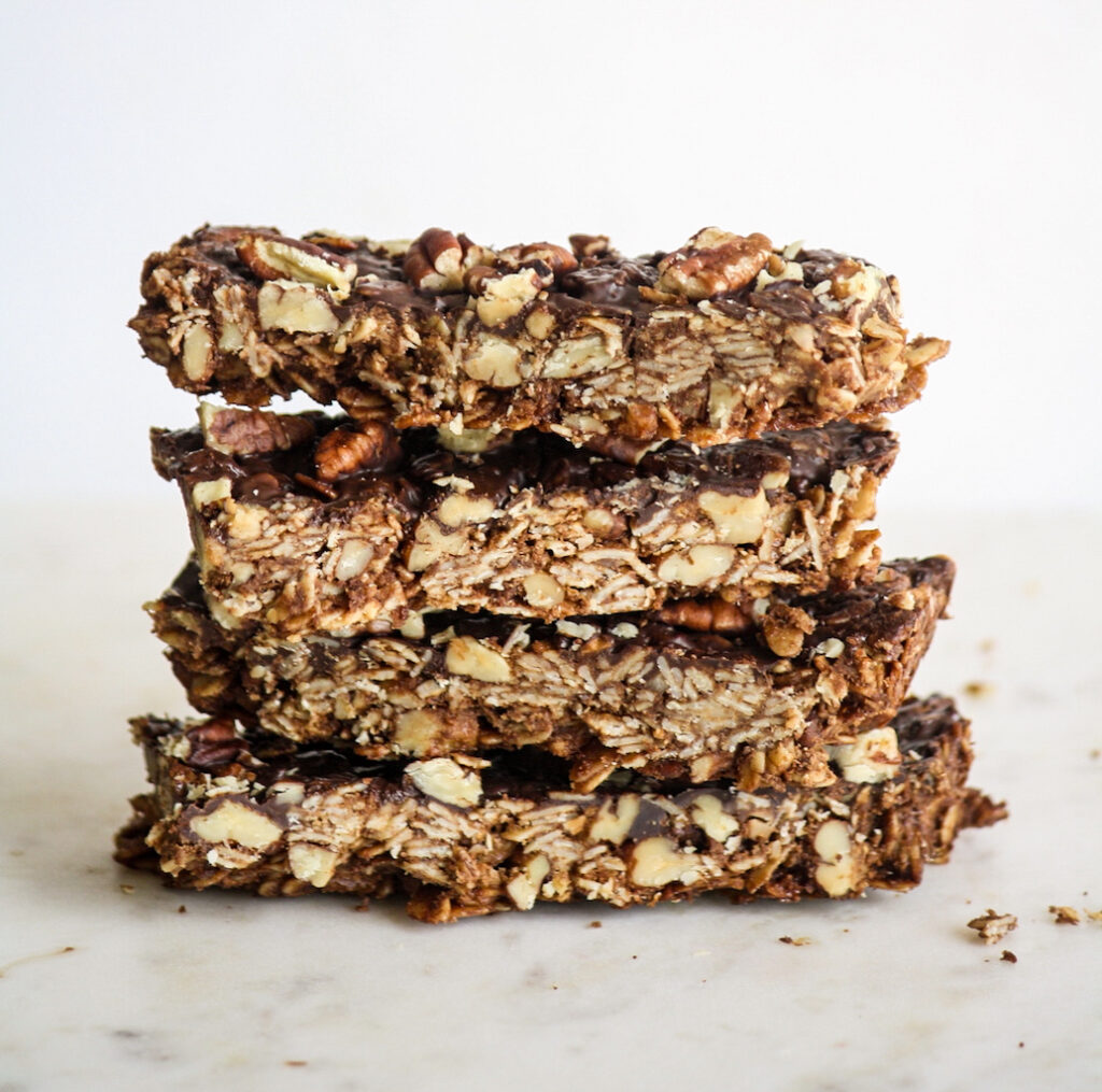 Crunchy, healthy granola bars with cocoa and toasted pecans, topped with a layer of melted dark chocolate