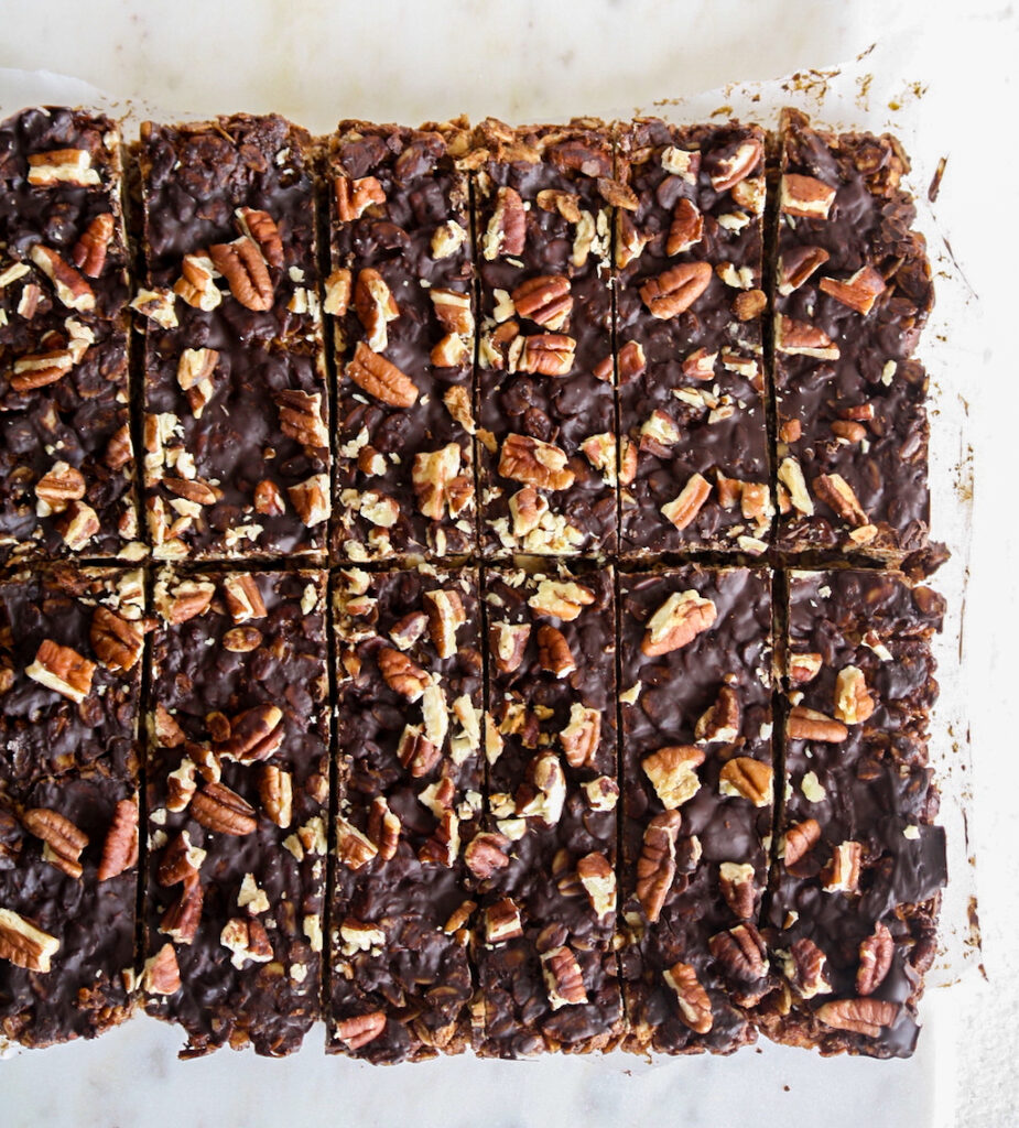 Crunchy, healthy granola bars with cocoa and toasted pecans, topped with a layer of melted dark chocolate