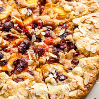 Rustic, flaky free-form pie with peaches, cherries and almond frangipane filling