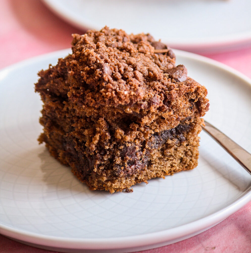 Soft chocolate cake with a cocoa sugar filling, chocolate crumb topping and chocolate chips in every layer!