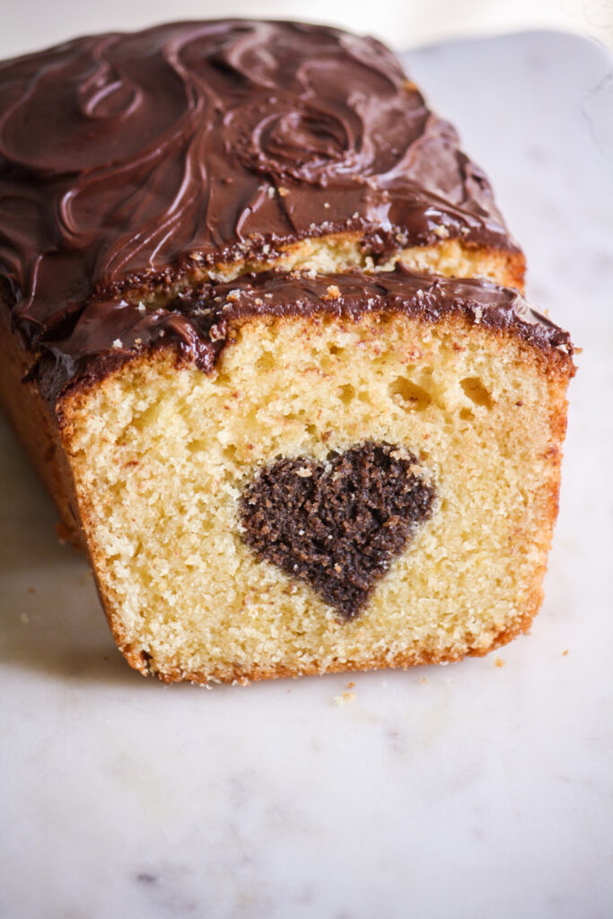 A buttery, mini loaf cake with vanilla cake on the outside and a surprise chocolate heart on the inside!