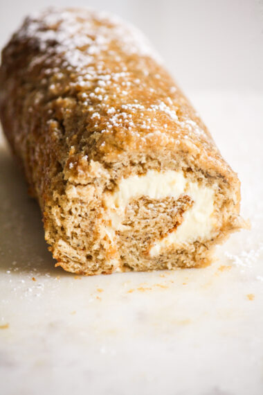 Soft, airy banana sponge cake rolled up with a tangy cream cheese frosting