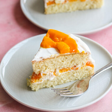 Soft desiccated coconut sponge cake filled with whipped cream and fresh mango