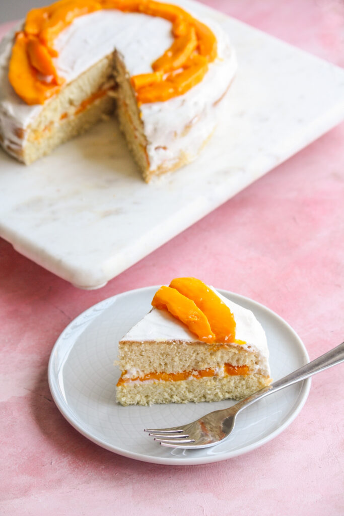 Soft desiccated coconut sponge cake filled with whipped cream and fresh mango