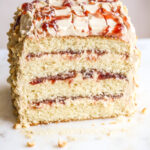 Small-batch, soft and tender butter cake layered with peanut butter frosting and strawberry jam