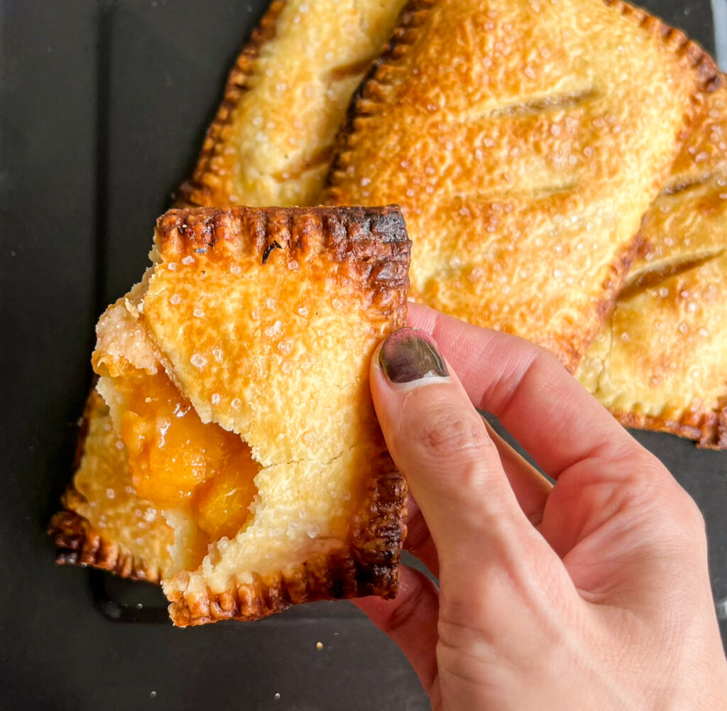 Buttery, flaky individual pies filled with jammy, cinnamon-scented peaches