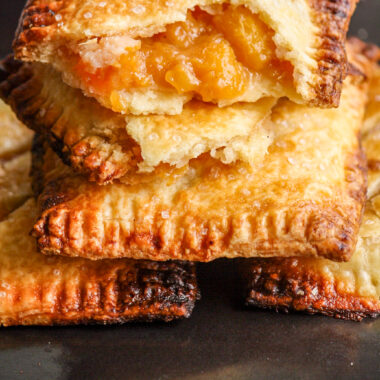 Buttery, flaky individual pies filled with jammy, cinnamon-scented peaches