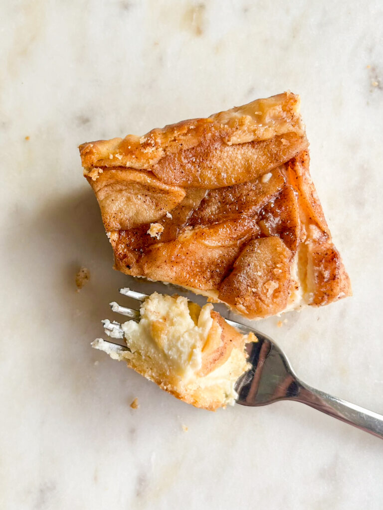 Creamy eggless cheesecake on a crisp shortbread base topped with caramelised apples