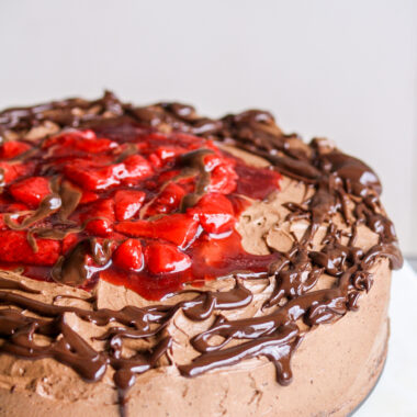 Simple chocolate cake layered with roasted strawberries and whipped ganache frosting