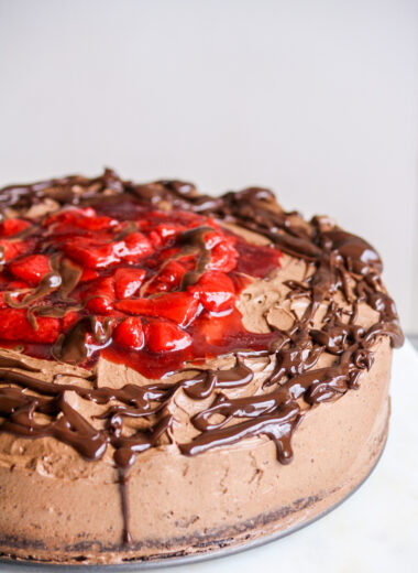 Simple chocolate cake layered with roasted strawberries and whipped ganache frosting