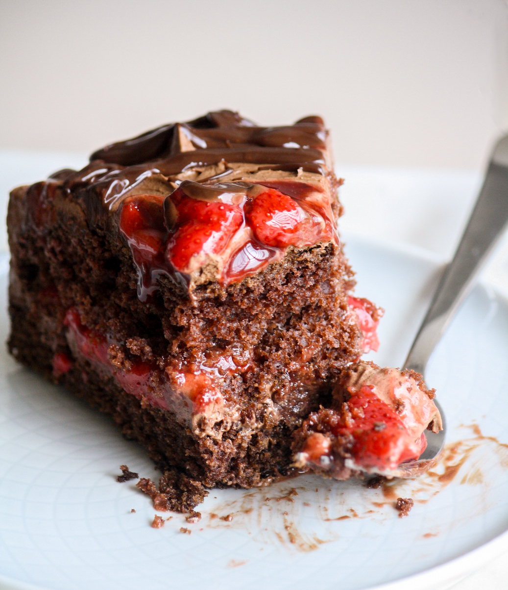 Simple chocolate cake layered with roasted strawberries and whipped ganache frosting