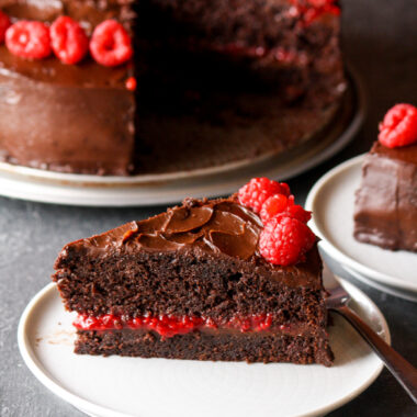 A rich and fudgy chocolate cake layered with dark chocolate ganache and filled with an easy raspberry filling