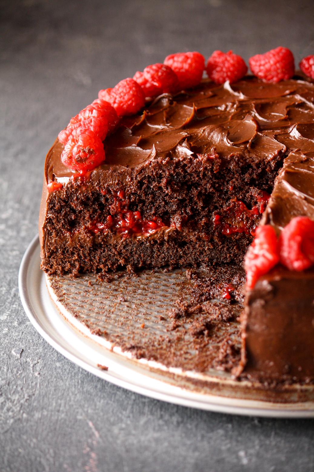 A rich and fudgy chocolate cake layered with dark chocolate ganache and filled with an easy raspberry filling