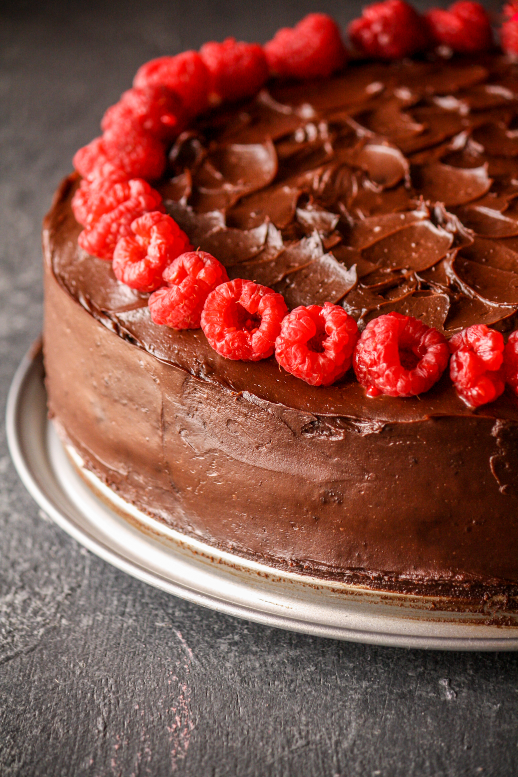 A rich and fudgy chocolate cake layered with dark chocolate ganache and filled with an easy raspberry filling